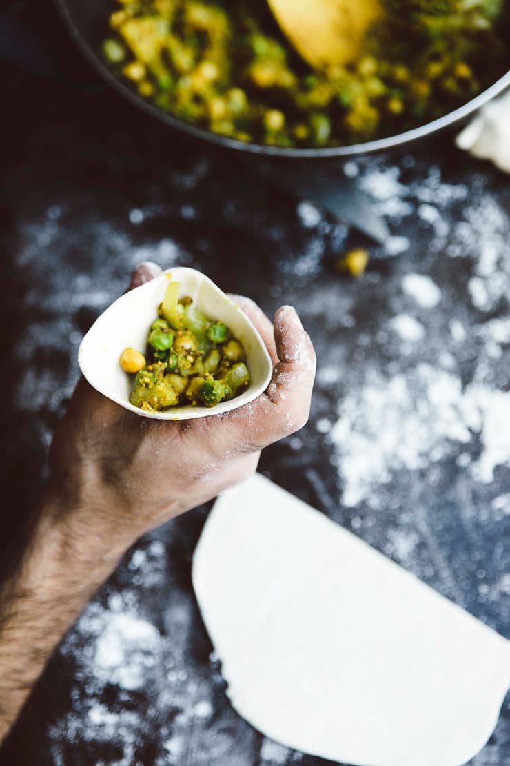 High angle view of samosas frying in hot oil in a deep pan